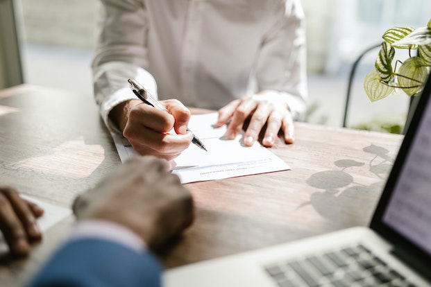 Woman signing life insurance contract